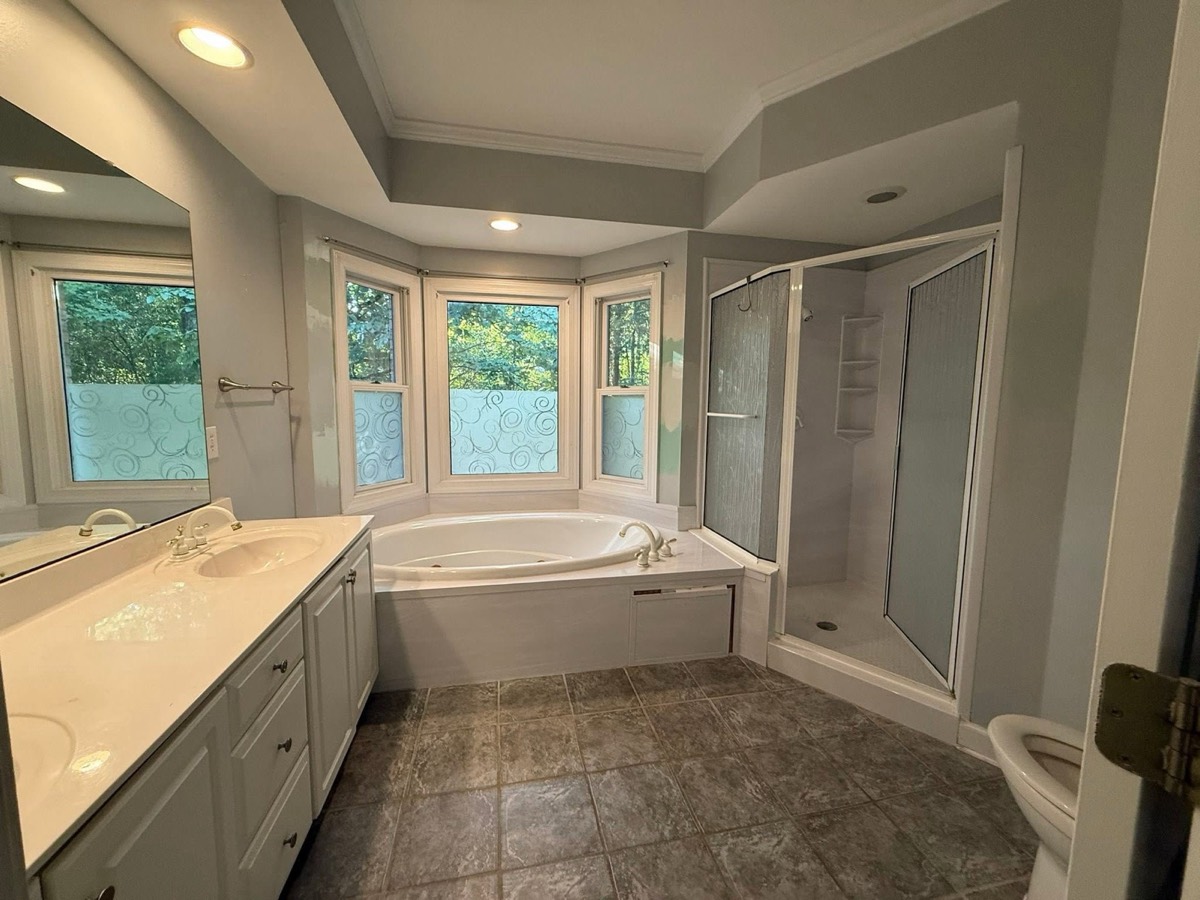 Marble primary bathroom before remodeling