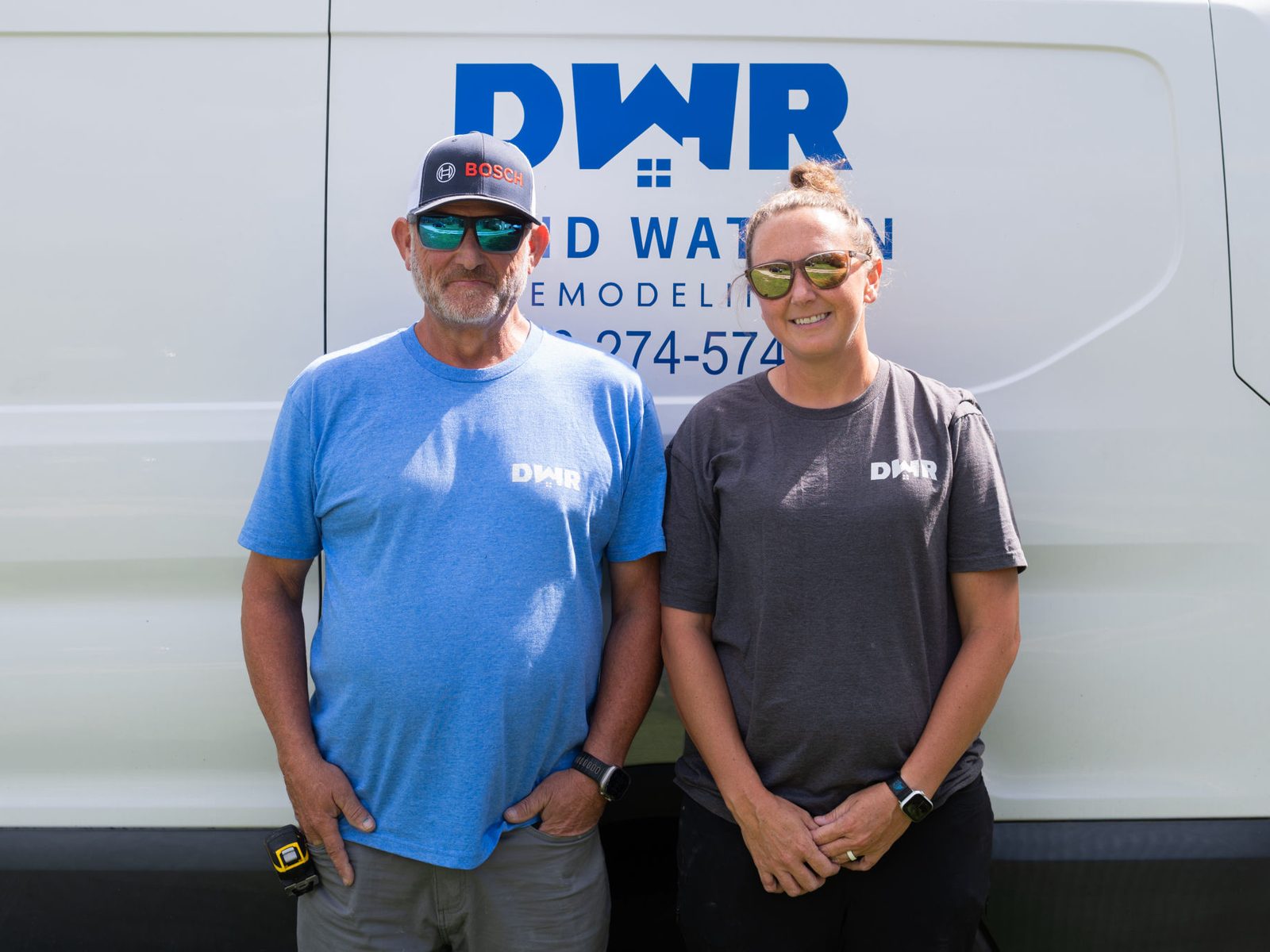 David and Rebecca Watson standing in front of the David Watson Remodeling van